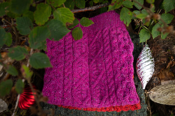 Selection of SnugíMadra sweaters in a seasonal themed setting